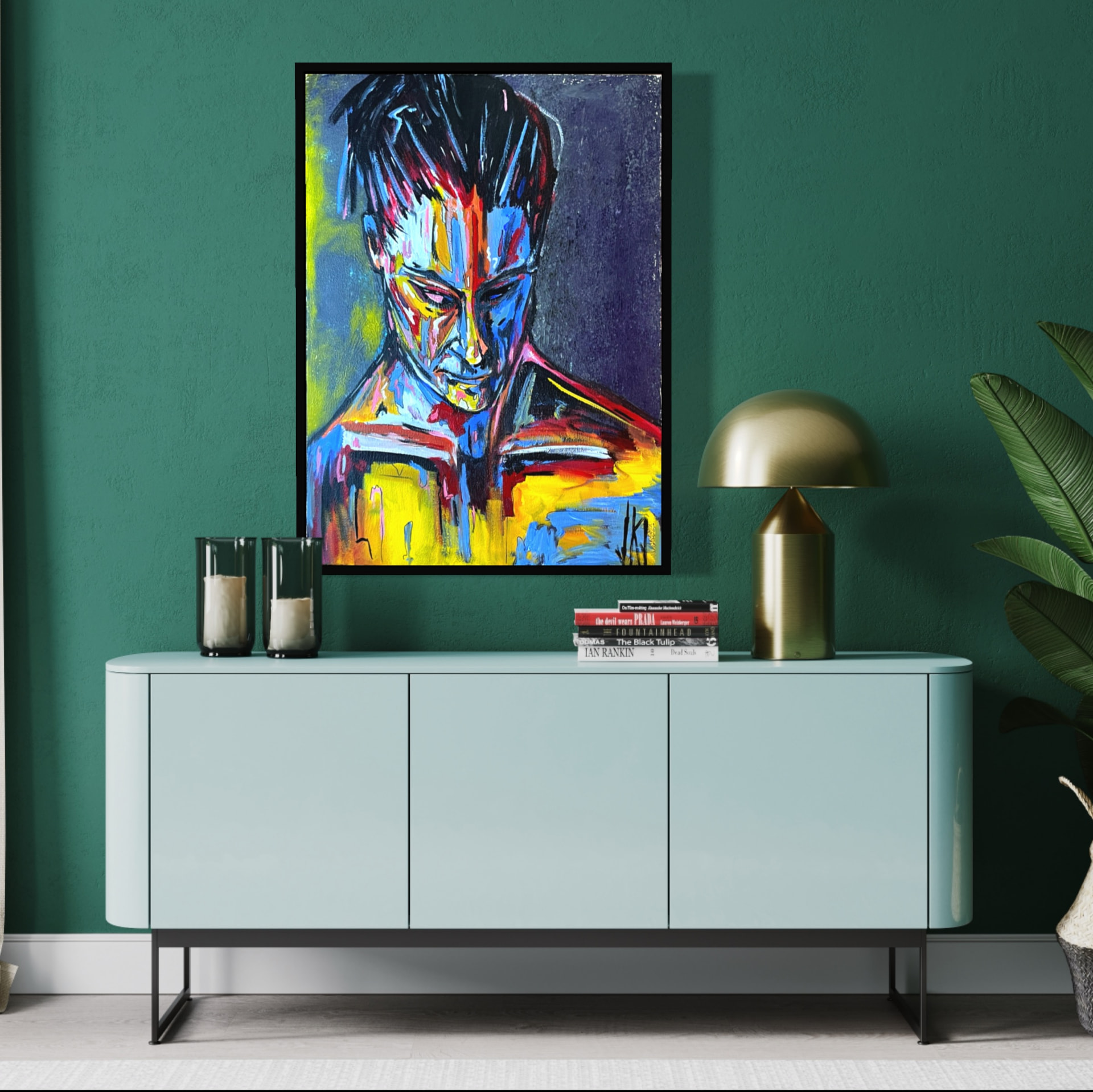 Painting of a contemplative figure in blue, yellow and red hung on a green wall above a mint credenza