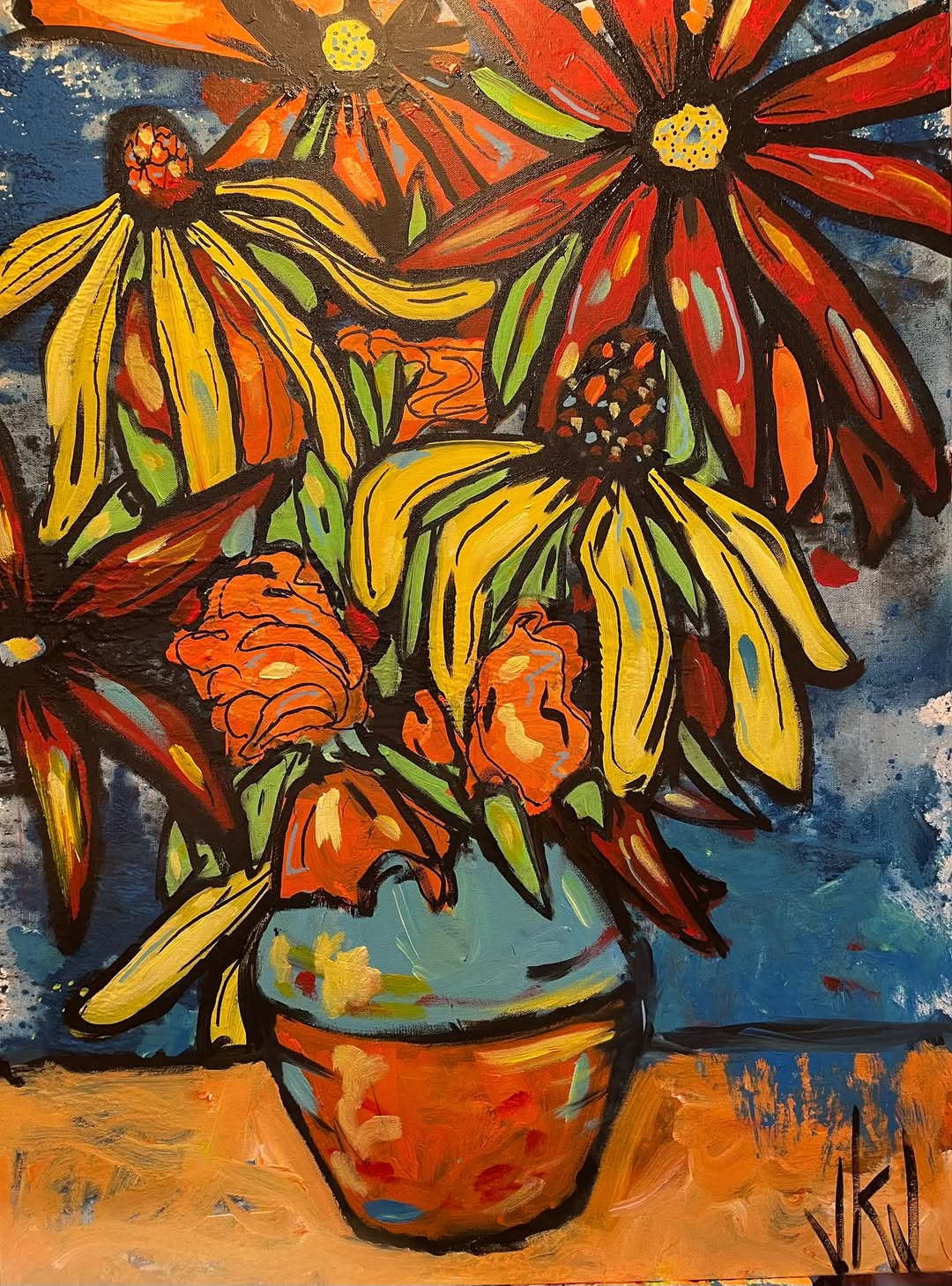 Yellow coneflowers in a blue and terracotta vase against a deep blue background