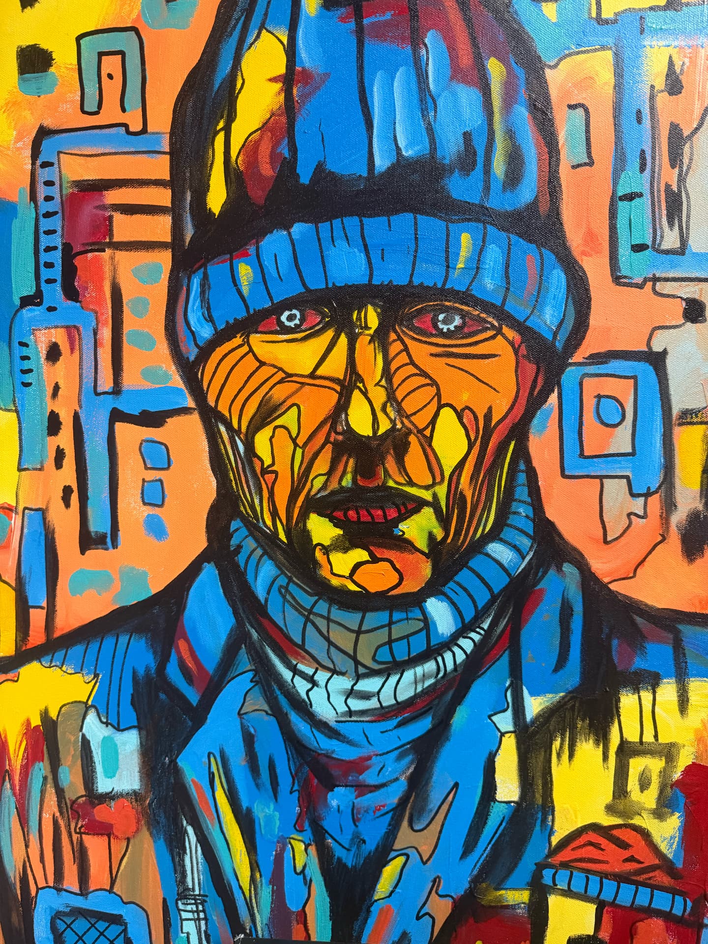 Portrait of a man in a blue knit hat against a Chicago skyline